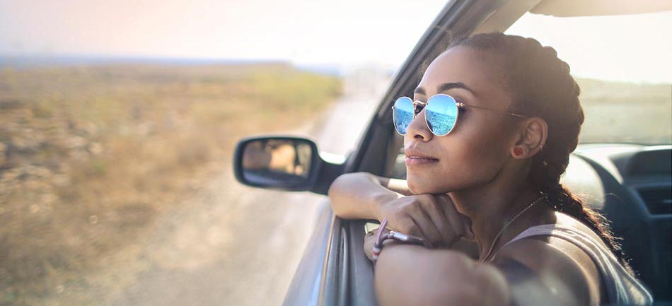 Trendy girl traveling by car